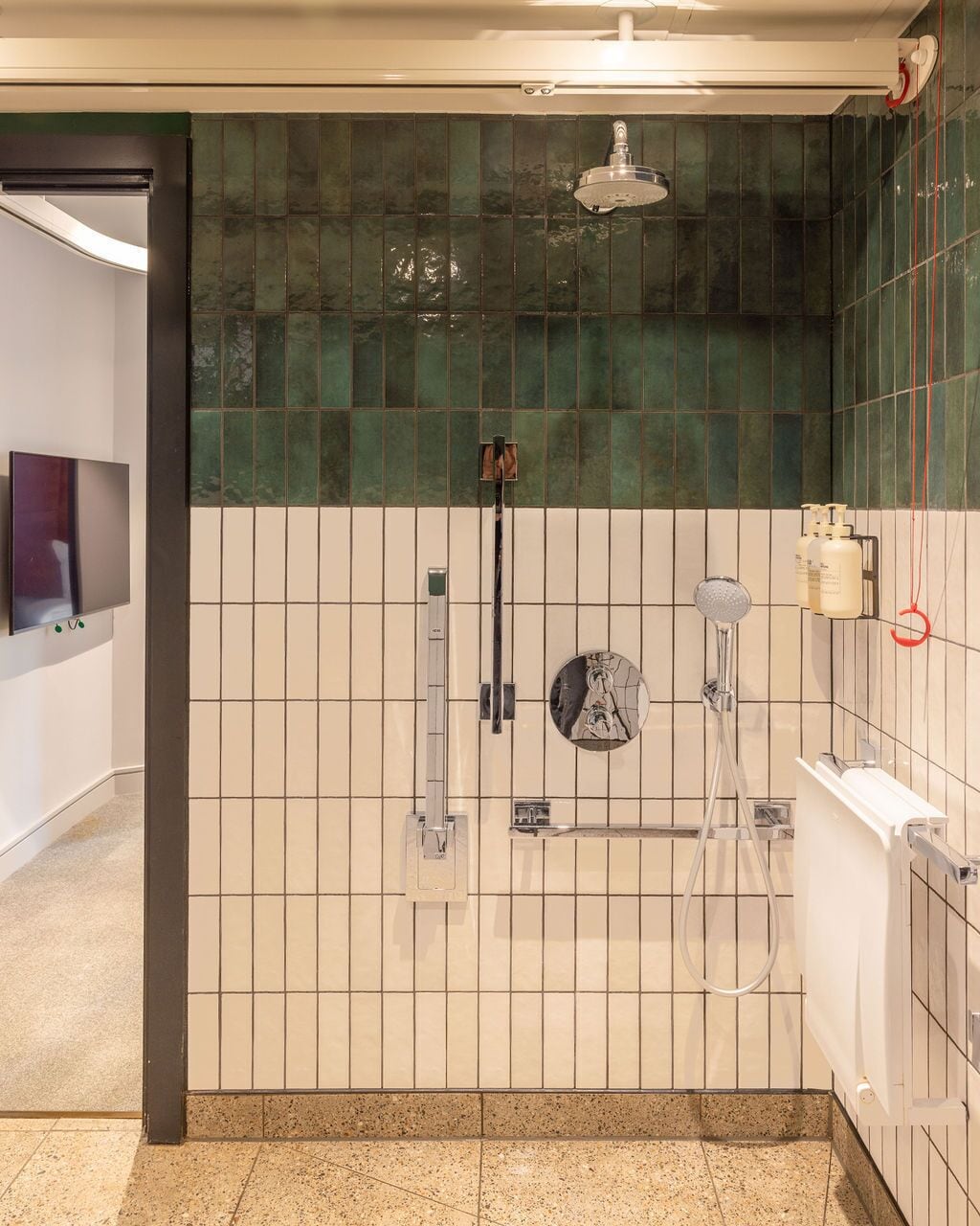 A modern bathroom with a shower, a toilet, and a sink.
