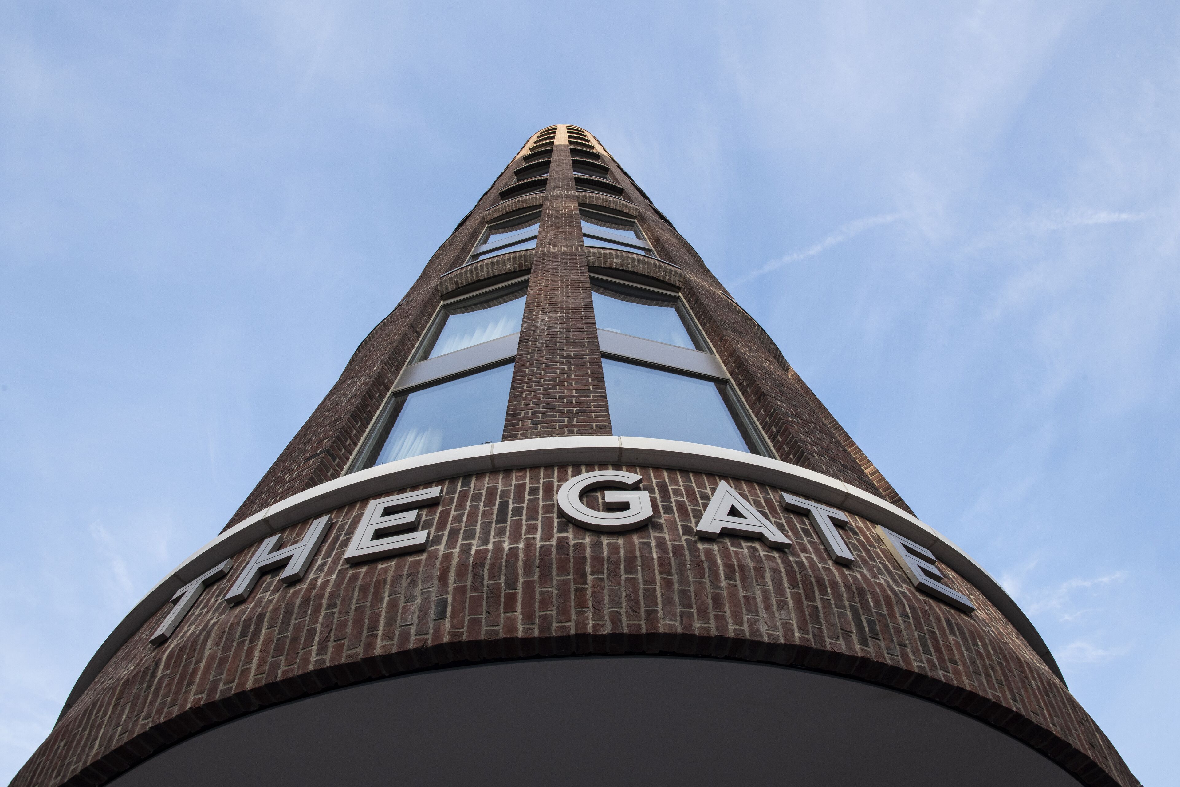 A tall brick building with the words "THE GATE" on its facade.