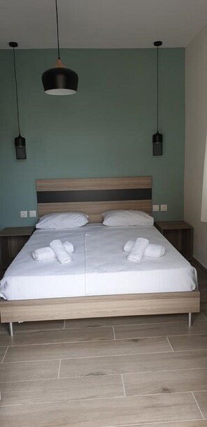 Restful retreat with a large bed and two bedside tables, each with a lamp.