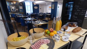 A breakfast buffet with various food items and a chalkboard menu listing prices. - Hotel La Belle Croix (Romont)