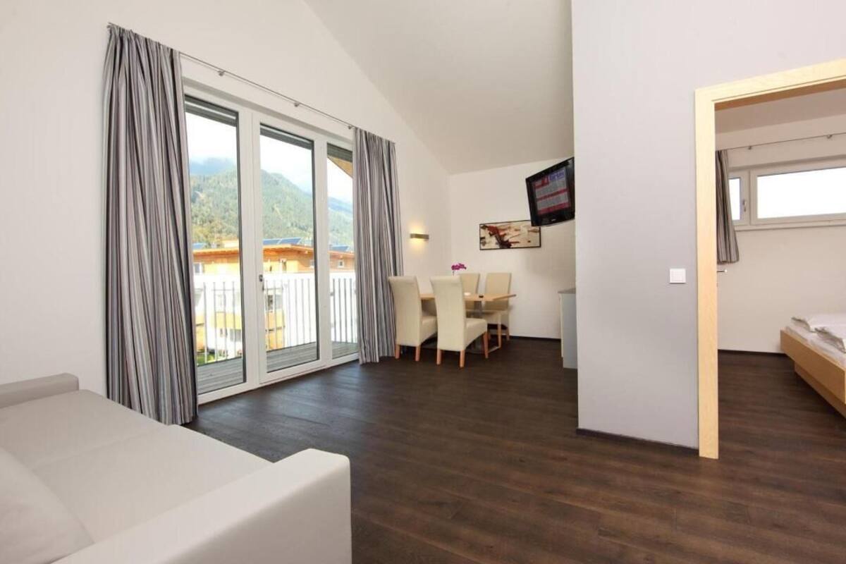 Une chambre moderne dotée d’un balcon, d’un coin repas et d’un lit.