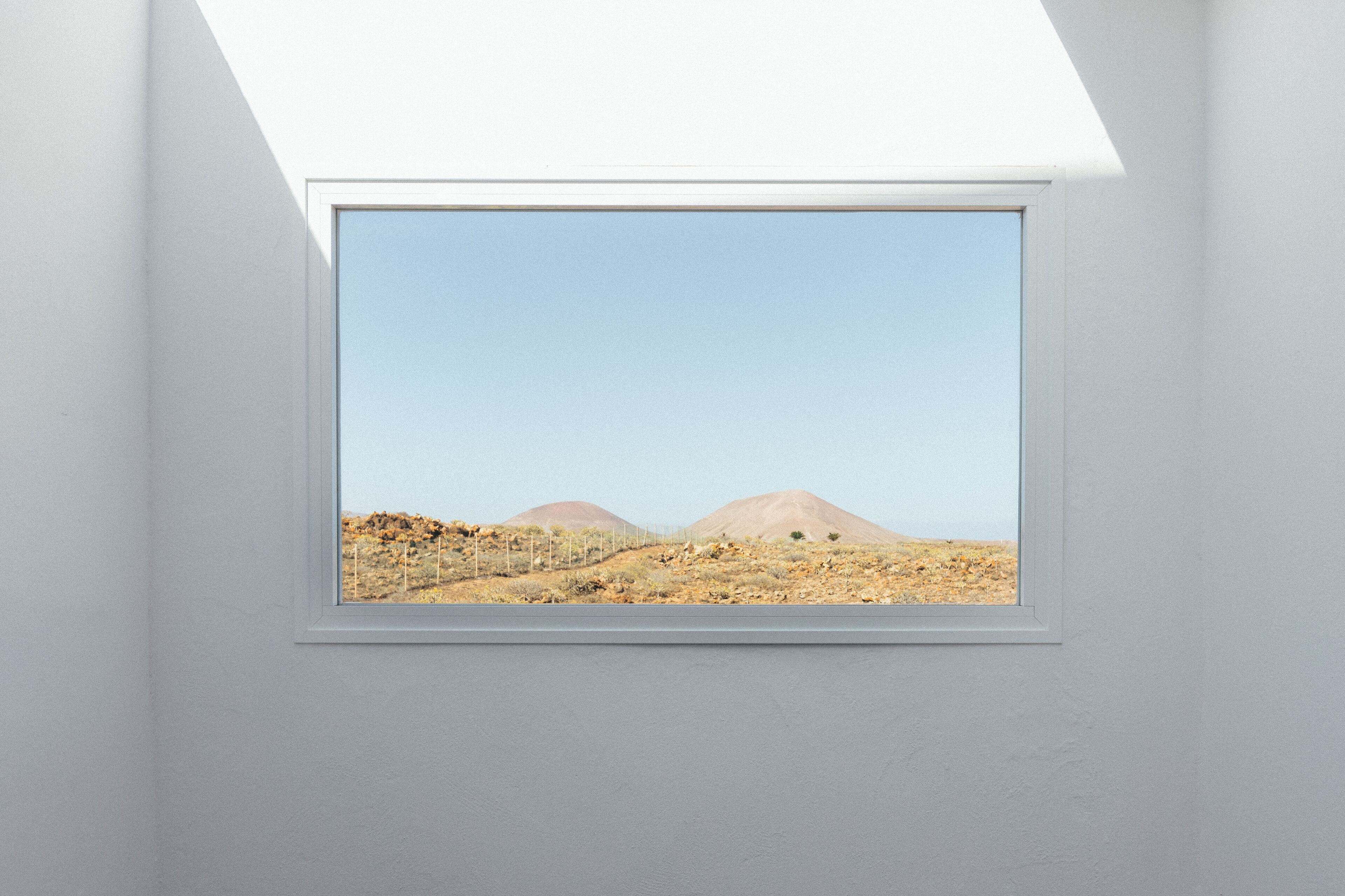 A skylight with a view of a desert landscape.
