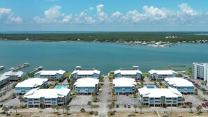A coastal hotel with multiple buildings, a marina, and a view of the ocean. - TWO POOLS, FISHING PIER, PRIVATE BEACH ACCESS, COZY ACCOMMODATIONS (Gulf Shores)