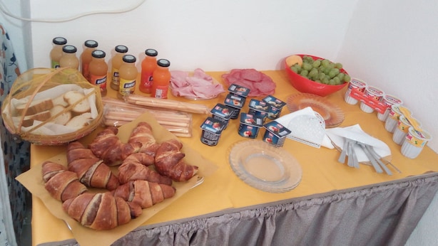 A table with various food items and condiments, including bread, meat, and beverages. - B&B Gerace (Badolato)
