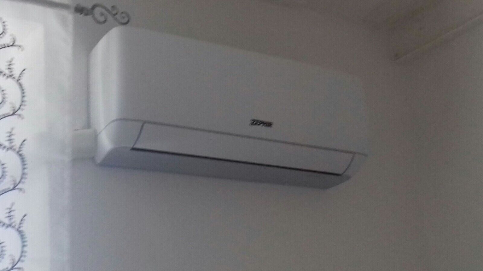 A white wall-mounted air conditioning unit.