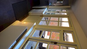 A modern kitchen with skylights, a built-in oven, and a dark backsplash. - 14 St Saviours Place, YORK (York)