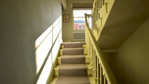 A staircase with a handrail and carpeted steps leading to a landing. - 14 St Saviours Place, YORK (York)