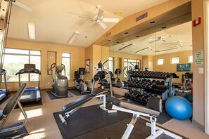 A gym with treadmills, elliptical machines, weight benches, and a mirrored wall. - Reduced Rates Just Posted! Cachet Condo (Scottsdale)