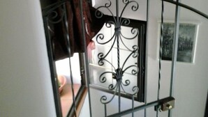 A staircase with a wrought iron railing and a decorative lantern. - La Dea Bendata (Piazza Armerina)