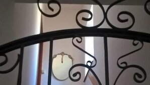 A staircase with a wrought iron railing leading to a landing. - La Dea Bendata (Piazza Armerina)