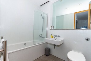 A modern bathroom with a glass-enclosed shower, a white sink, and a toilet. - 1 Bed- Pureserviced 42 Brewhouse (Plymouth)