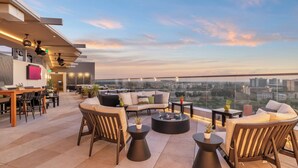 A rooftop terrace with seating, a bar area, and a view of the cityscape. - JW Marriott Anaheim Resort (Anaheim)