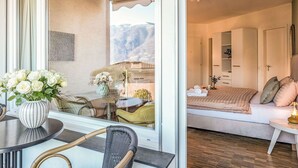 A modern bedroom with a bed, bedside table, and a view of a balcony. - Beautiful apartment for 2 people with WIFI, TV, balcony and pets allowed (Ascona)