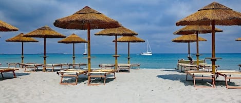 On the beach, sun-loungers