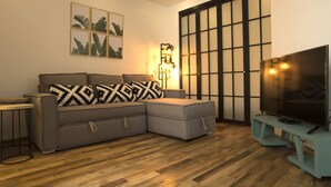 A modern living room with a grey sectional sofa, a small round table, a floor lamp, and a TV on a stand. - Central Luxury house - Condesa Neighborhood (Colonia Condesa)
