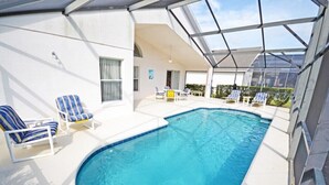 A swimming pool with lounge chairs and a covered patio area. - Spacious pool home located in popular gated community of Westhaven (Davenport)