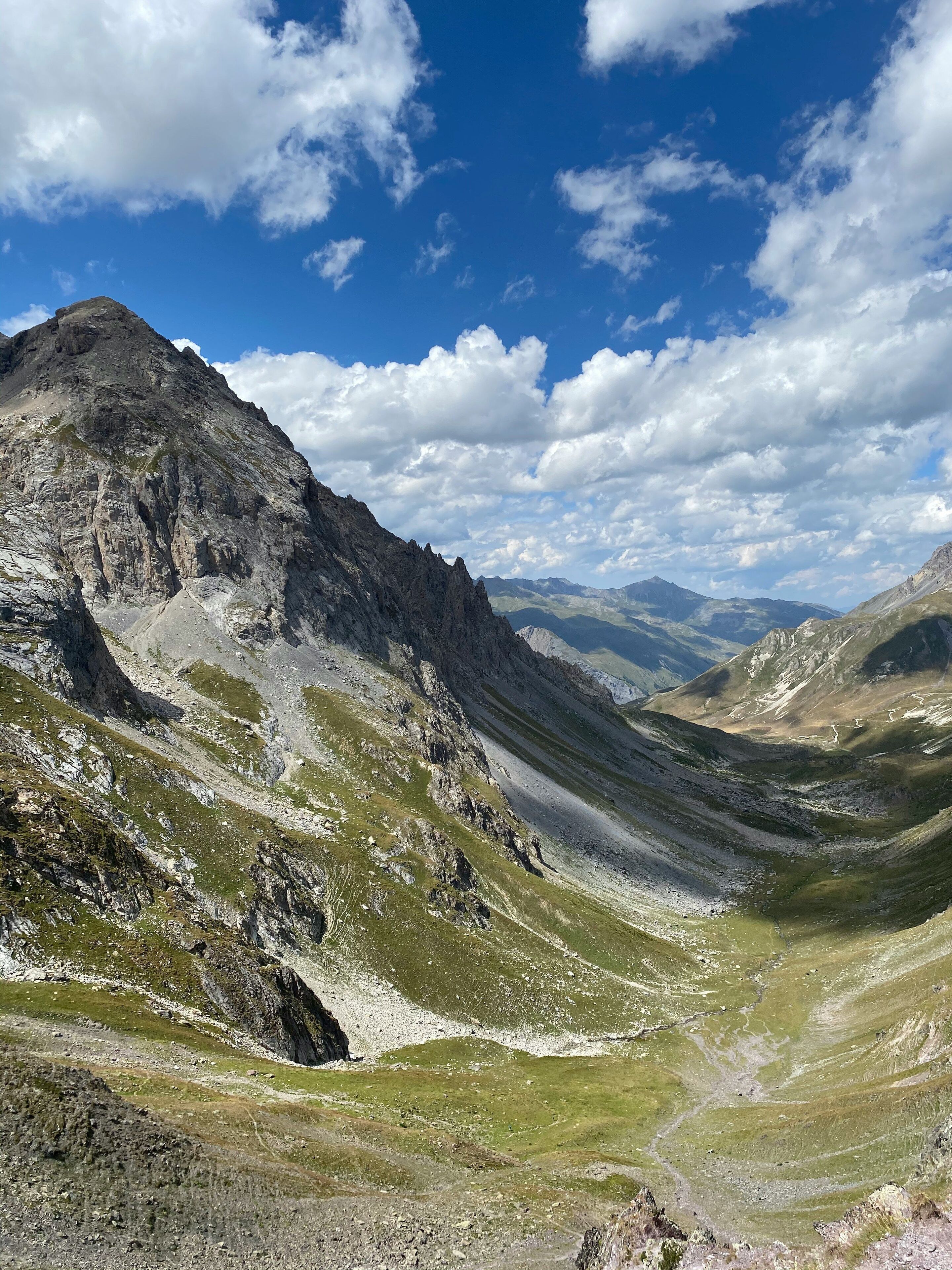 A mountainous landscape with rocky terrain and green patches.