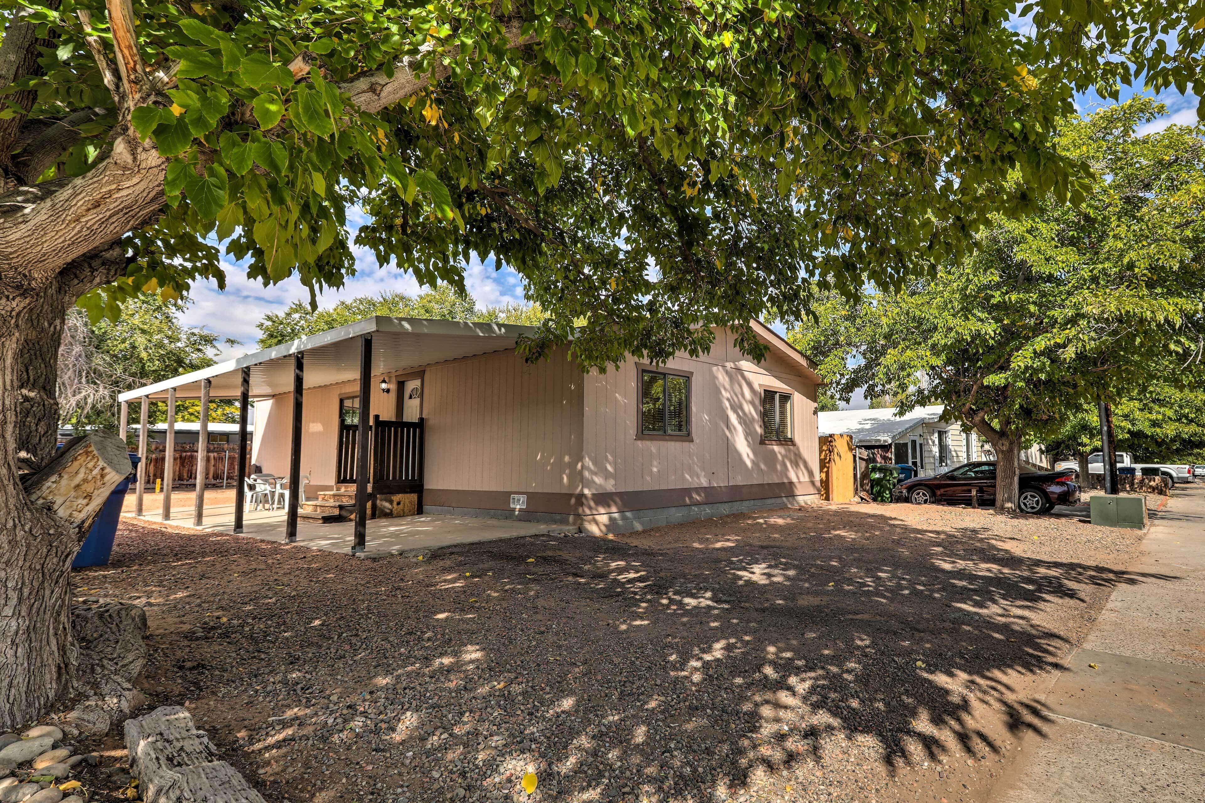 A single-story building with a covered porch, a small window, and a door.