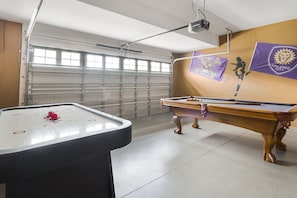 Enjoy games and entertainment in this sports-themed room with a pool table and air hockey table.