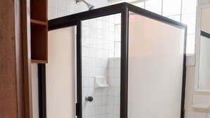 A bathroom with a shower enclosure, a toilet, and a sink. - SIMI-HA-2BR-TULUM... (TULUM)