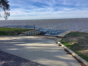 A waterfront road with a concrete barrier and a small structure near the water. - Casa De Paradisio 2 by Destin Getaways (Miramar Beach)