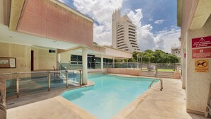 An indoor swimming pool with clear water, surrounded by a tiled walkway and a covered seating area. - Hotel Sorrento Santa Marta (Santa Marta)
