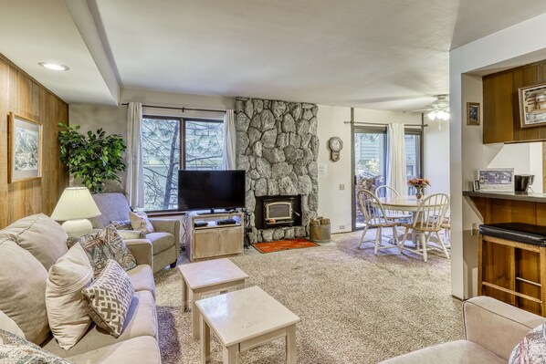 Relax in a spacious living area with a sofa, flat-screen TV, and stone fireplace.
