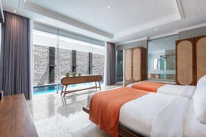 A modern hotel room with a large window, a wooden bench, two beds, and a small table. - Nunamkhalu Private Villas & Spa (Kutuh)