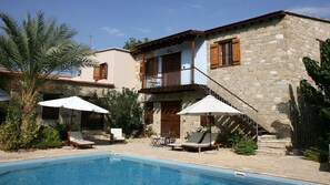 Relax by the pool surrounded by a tranquil atmosphere and a balcony with a view.