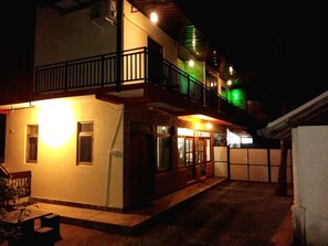 A two-story building with a balcony and a ground-level entrance. - The Summer Resort (Udawalawa)