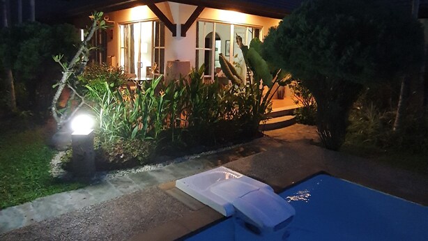 A house with a swimming pool at dusk.
