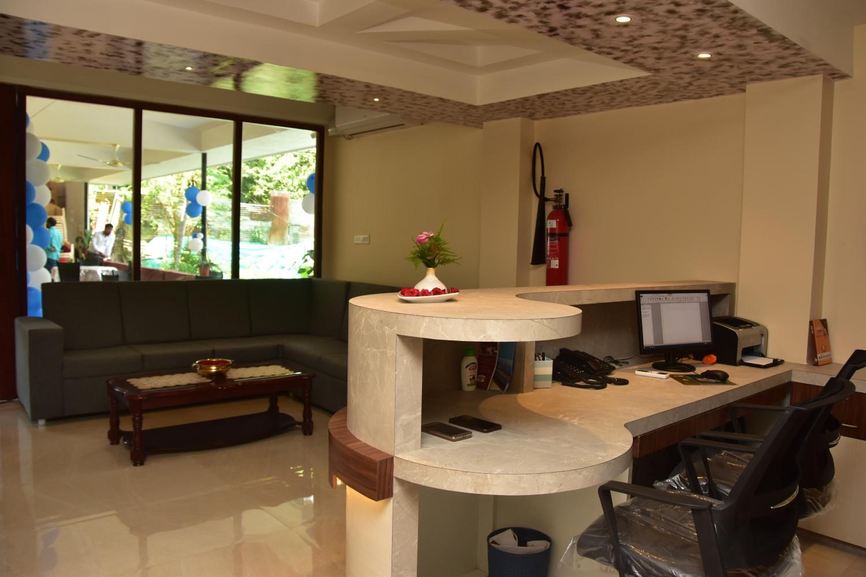 A reception area with a curved desk, a sofa, and a coffee table.