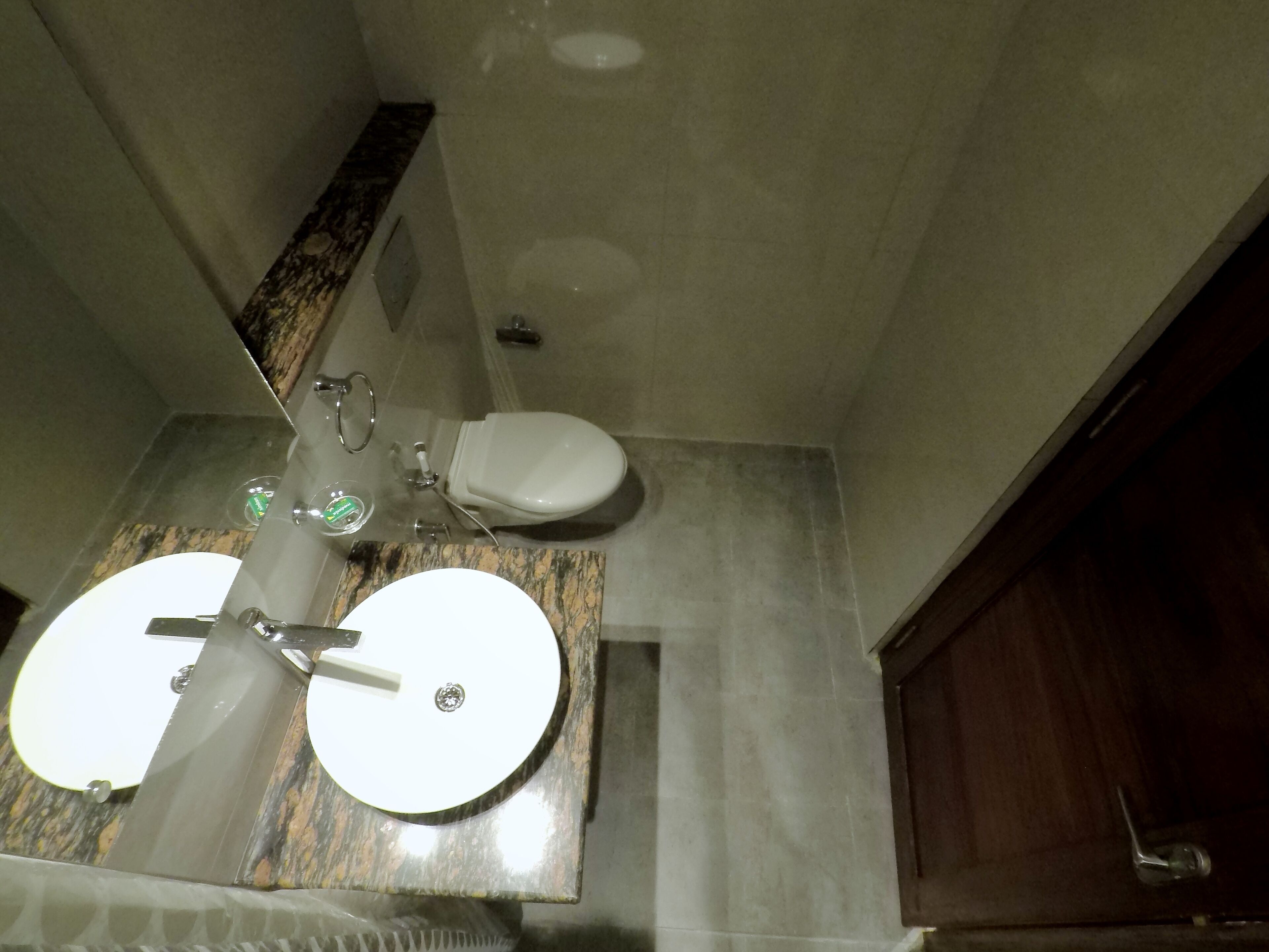 A bathroom with two sinks, a toilet, and a shower.