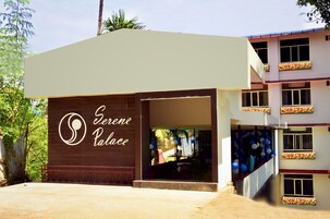 A building with a sign reading "Serene Palace" and a staircase leading to an upper level.