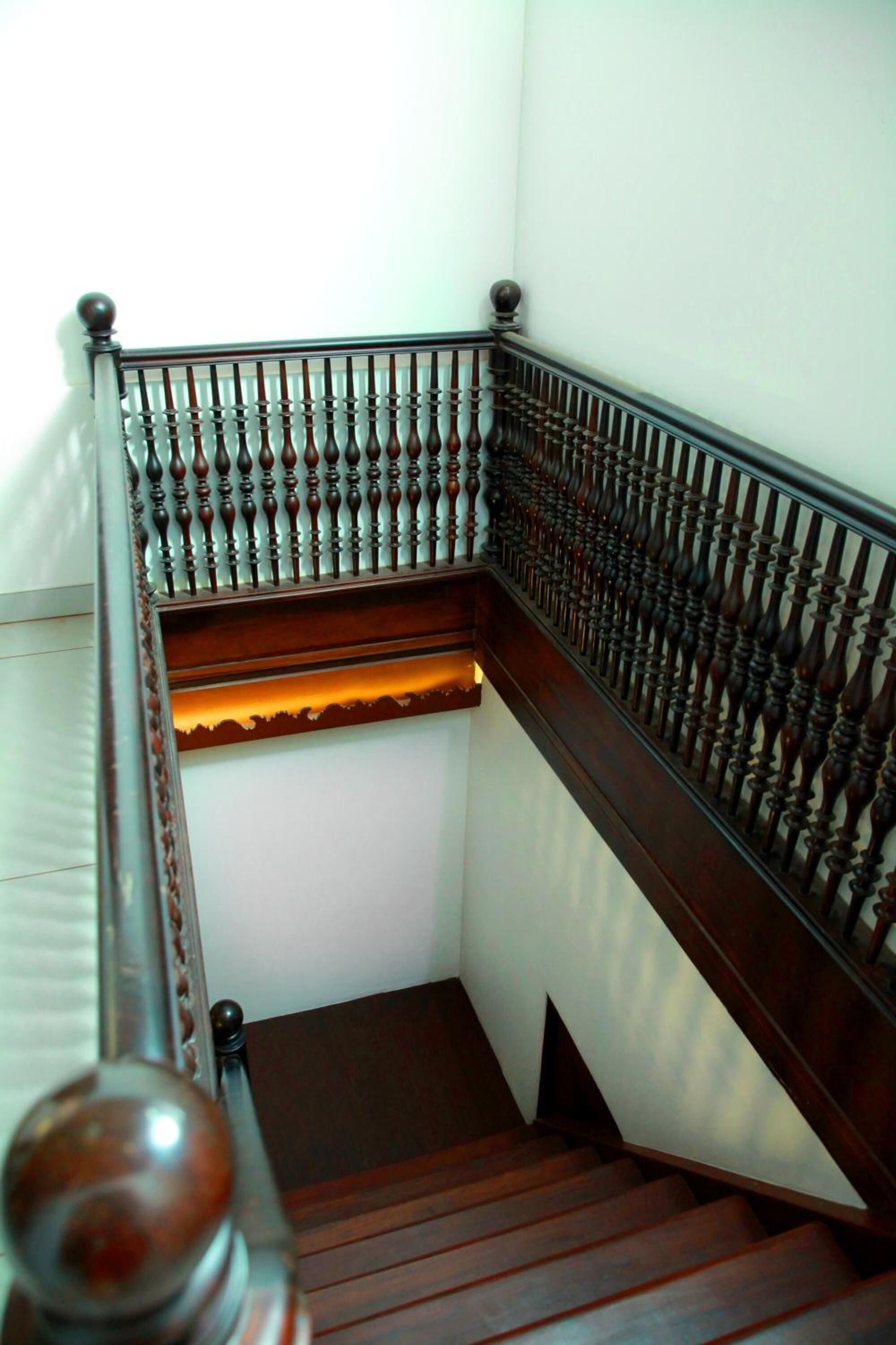 A wooden staircase with a balustrade.