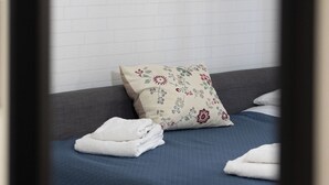 A hotel room with a bed, a pillow, and a wall-mounted picture of a bridge and building. - Nicla's Home - Near Trastevere Station (Roma)