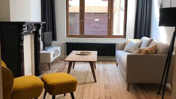 Family Apartment, 2 Bedrooms | Living area | 38-inch Smart TV with cable channels, TV