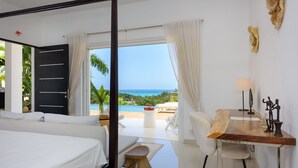 A bedroom with a large bed, a desk, and a view of the ocean. - Fabulous Experience AC, Gym, Chef and Staff Available  (Las Terrenas)