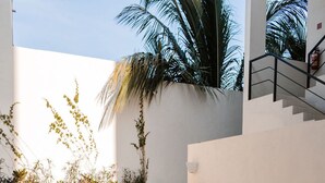 A modern outdoor pool area with lounge chairs and a staircase.