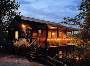 A log cabin with a porch, wooden steps, and a railing. - Honey Bear | 2 King Suites, FirePit, HotTub, Views, Pets (Sevierville)