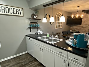 Enjoy a well-equipped kitchen with a double sink, coffee maker, and ample storage.