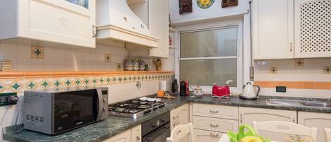 Microwave, oven, dishwasher, dining tables