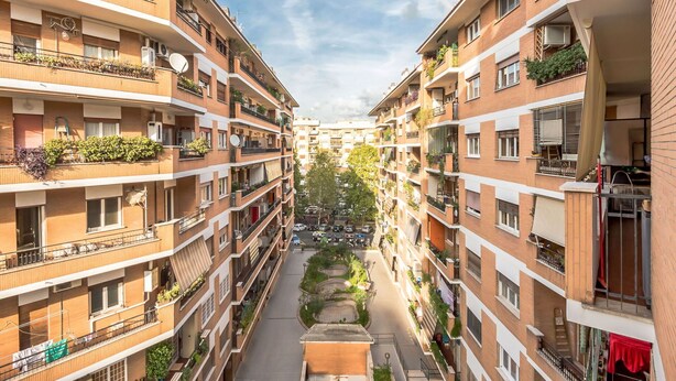 A multi-story residential building with balconies, a central courtyard, and a street view. - Cosy apartment for 6 guests with WIFI, A/C, TV and balcony (Rome)