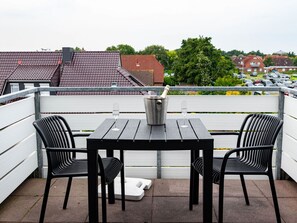 Enjoy a romantic evening on this outdoor terrace with a table for two, complete with champagne and glasses.