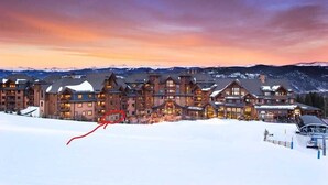 A large lodge with multiple buildings, a ski lift, and a snowy landscape. - Luxury 3 Bedroom Condo - Ski-In Ski-Out, Hot Tub - Grand Lodge on Peak 7 (Breckenridge)