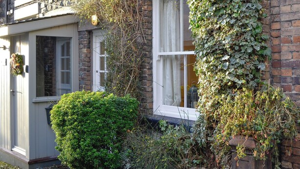 A stone building with ivy-covered walls and a small window. - 2 bedroom accommodation in Keswick (Keswick)