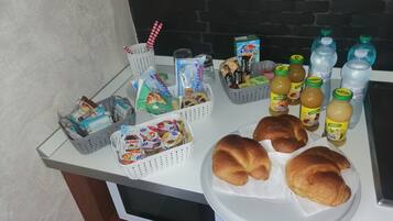 A breakfast buffet with various food items and beverages.