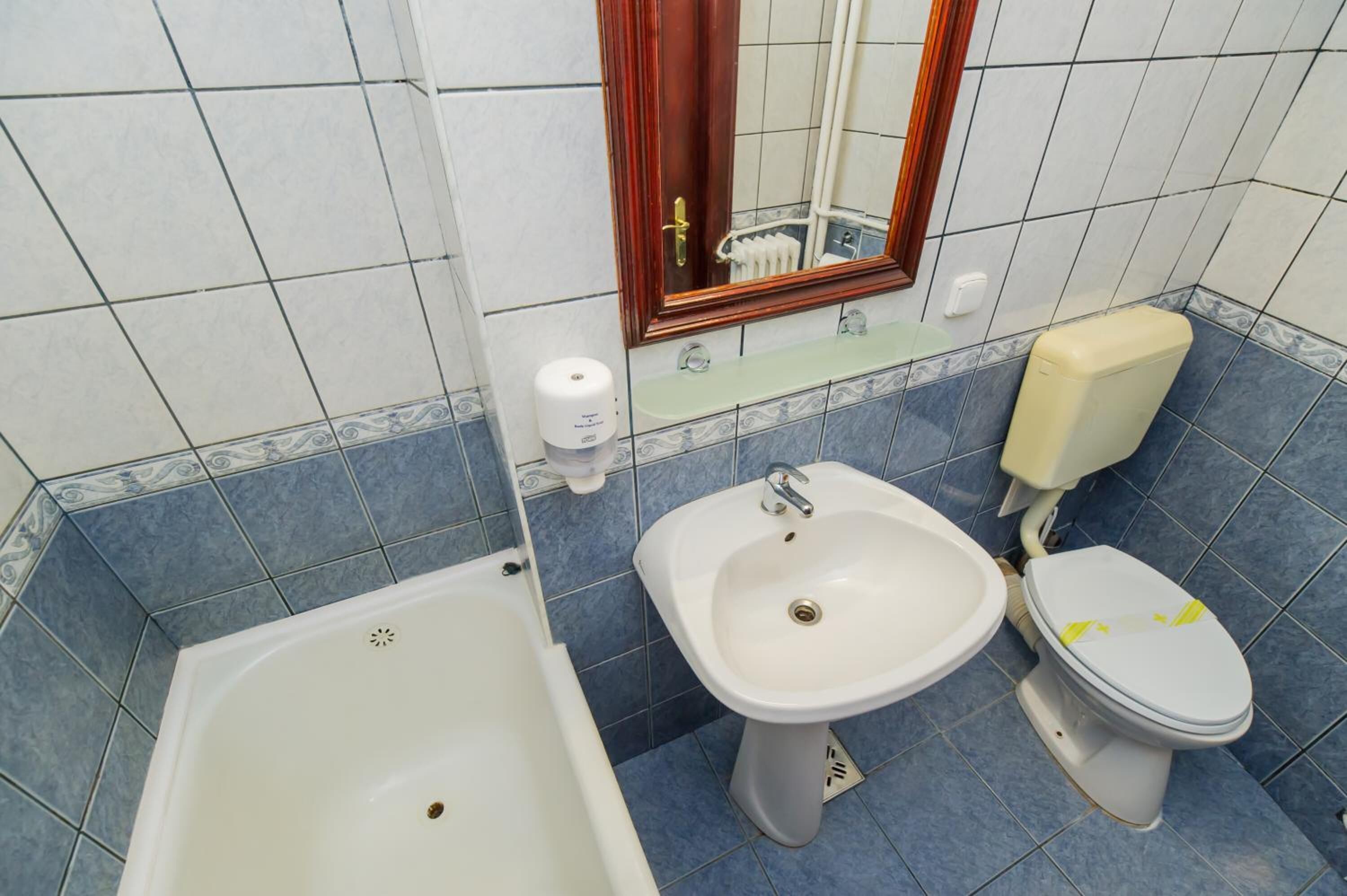 A bathroom with a bathtub, a sink, and a toilet.