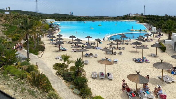 A beach resort with a large swimming pool, sun loungers, and umbrellas. - Exclusive 3-bed Penthouse Alcazaba Lagoon (321) (Casares)