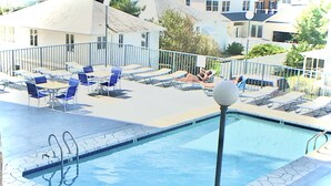 A swimming pool with lounge chairs and a poolside area. - Flood Damaged - Renovated 2026 ~ Excuse Glitches - Still Quaint VINTAGE Studio (Rehoboth Beach)